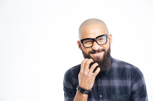 Closeup of handsome baldheaded young african american man in glasses scratching his beard