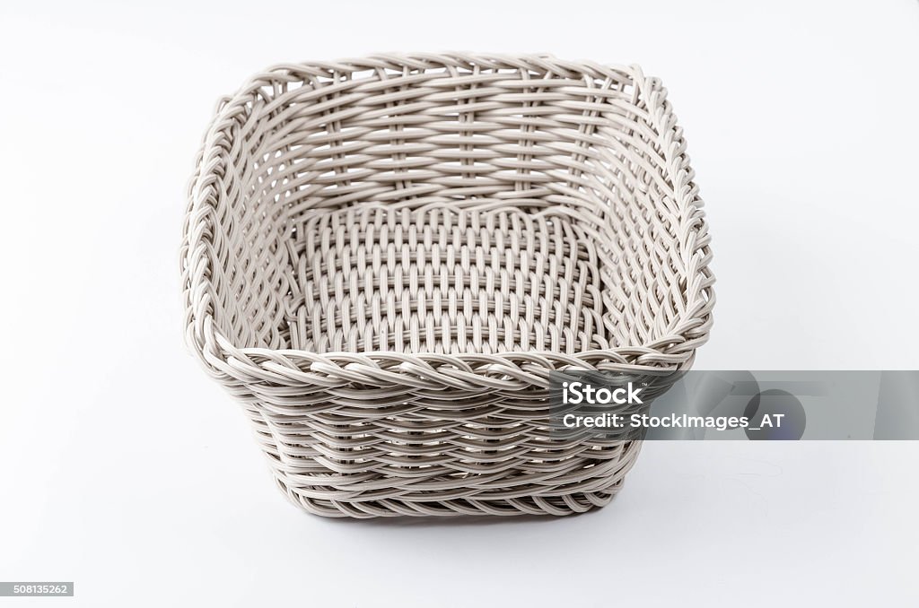 New plastic woven basket Close up of a  new sandy brown plastic basket. Lots of details. Photo made indoor with a modern photo studio. Abstract Stock Photo