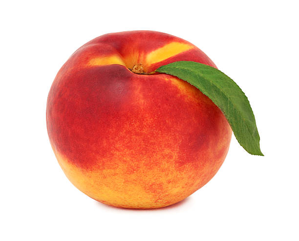 istock One whole ripe nectarine with green leaf (isolated) 508135352