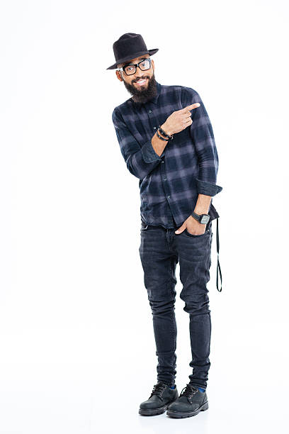 istock Smiling bearded african man in hat and glasses pointing away 508136272