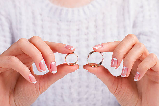istock Beautiful female fingers holding wedding rings. 508137620