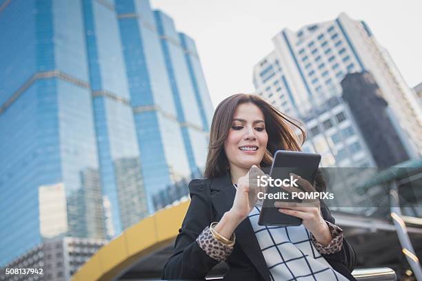 Smart Business Woman Looking Confident And Smiling Holding Tablet Computer Stock Photo - Download Image Now