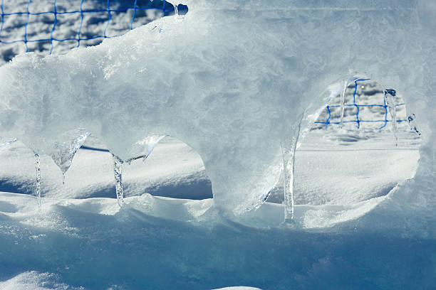 Melting glacial block of ice with icicles closeup.