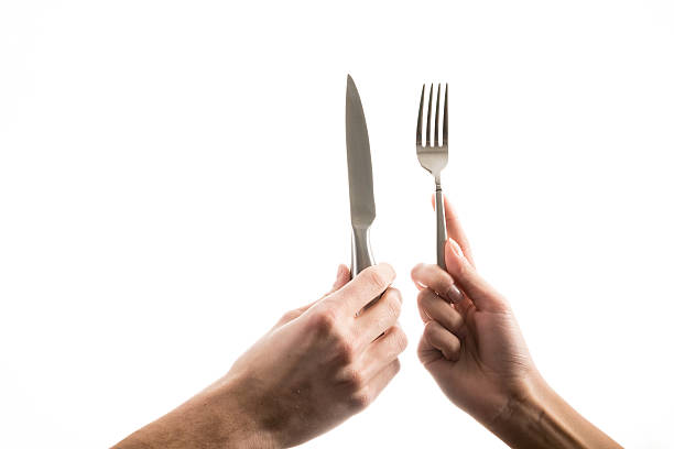 istock Hands Holding Knife and Fork Against White Background 508140772