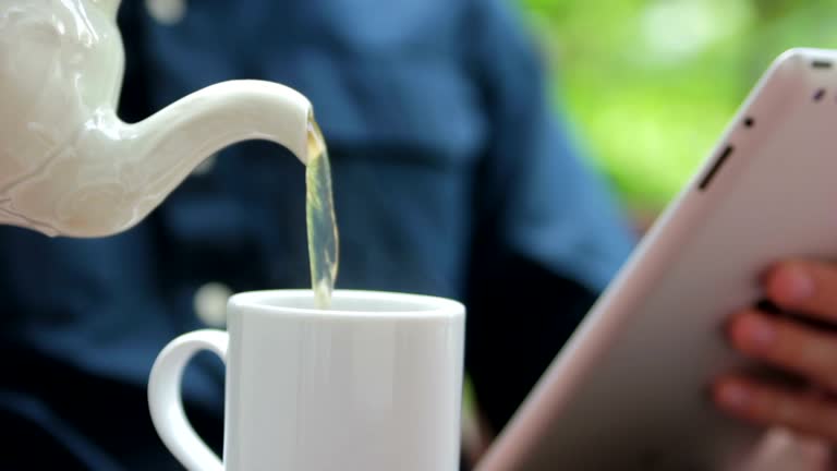 Slow Motion of man pouring tea