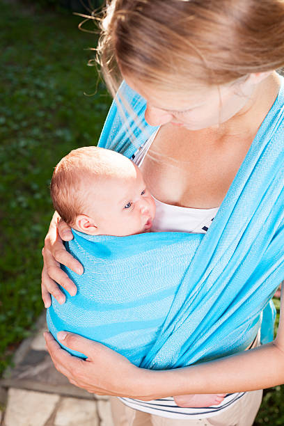 istock Mother with newborn baby in sling 508142374