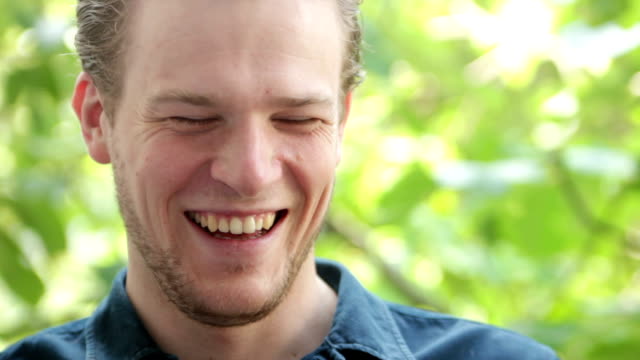 Man drinking from his cup of coffee, laughing