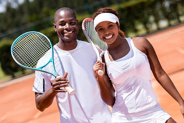 Happy tennis players Happy tennis players smiling at the court tennis outfit stock pictures, royalty-free photos & images