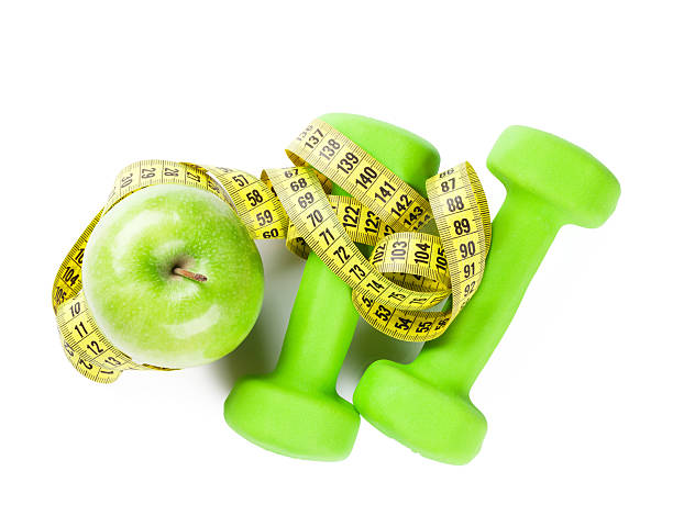 istock Dumbbells, apple and tape measure 508150288