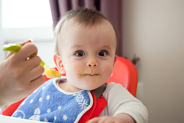 istock curious smeared with food baby, eating vegetable puree 508151316
