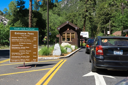 El Portal, California, USA - May 26, 2014: A park ranger and traffic waiting to enter the famous Yosemite National Park in California.