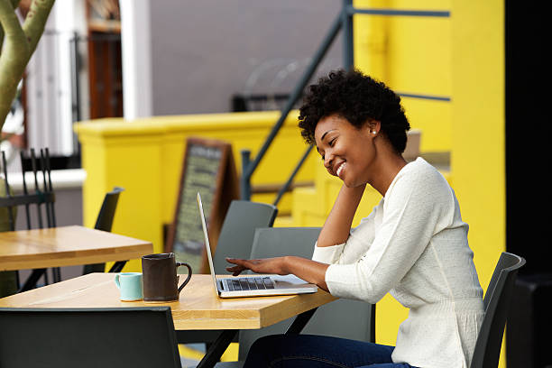 istock Happy woman using laptop at cafe 508152516