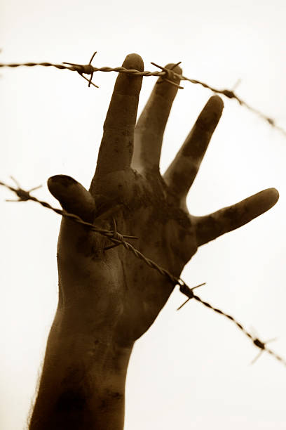 istock Refugee men and fence 508153864