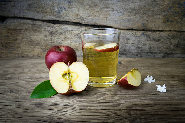 istock Apple juice and apples on a wooden table 508154280