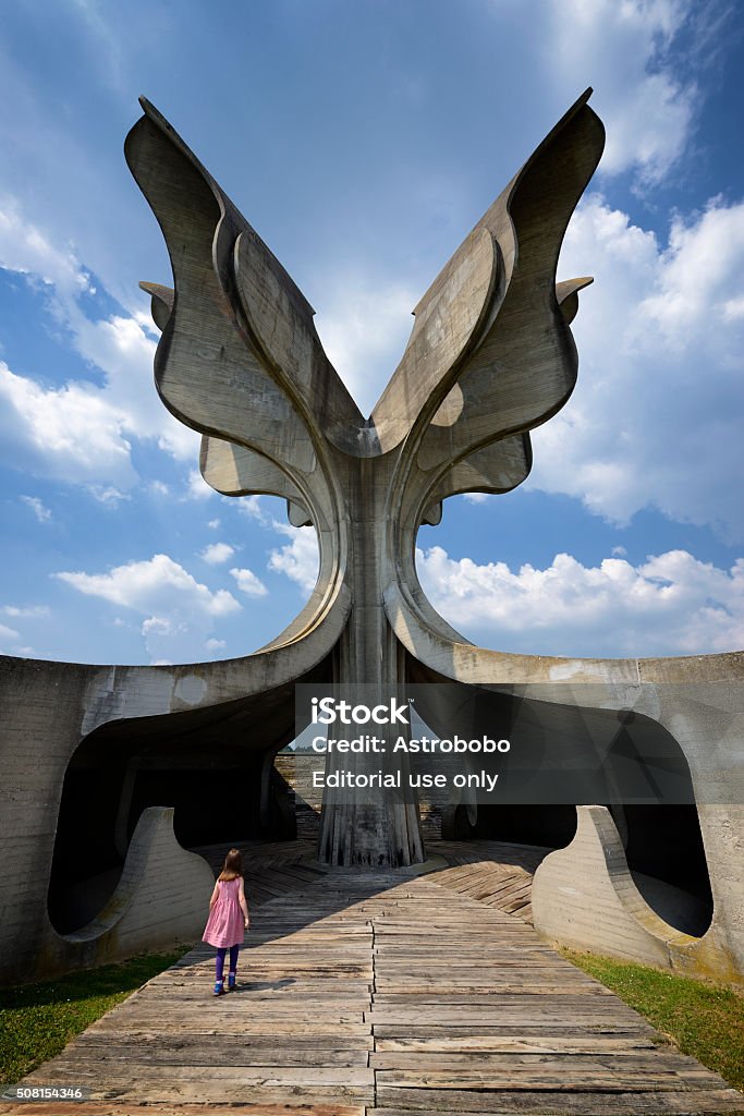 Jasenovac WWII Flower Memorial Jasenovac, Croatia - June 4, 2015: Young girl visiting the Flowert Memorial site at the former Jasenovac WWII concentration camp in Croatia, former Yugoslavia. The Flower Monument was designed by Bogdan Bogdanović and built in 1966. Architecture Stock Photo