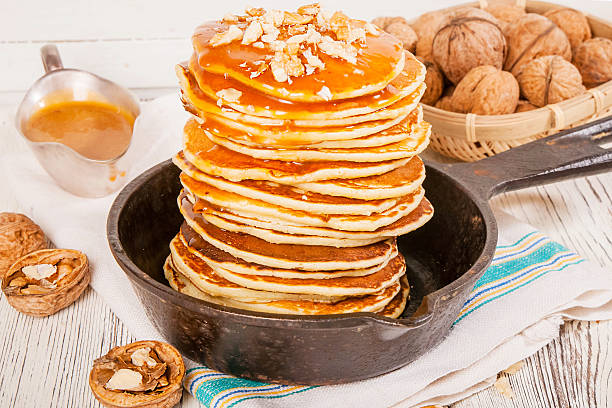 istock Pancakes with caramel and nuts on an old wooden background. 508155868