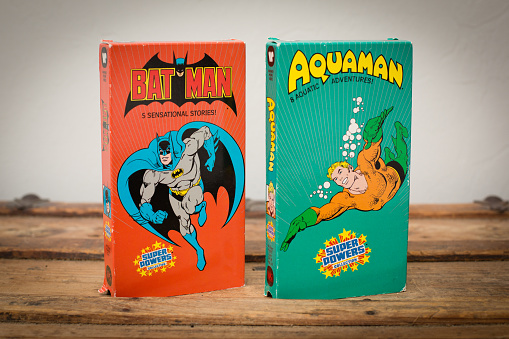 Fort Myers, FL, USA – January 6, 2016: Two VHS tape cartoon comic book movies from the 1980s featuring DC Comics superheroes Batman and Aquaman.