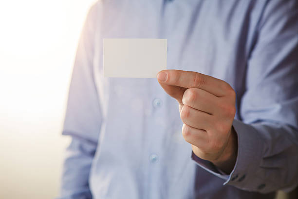 istock Man holding white business card 508158760