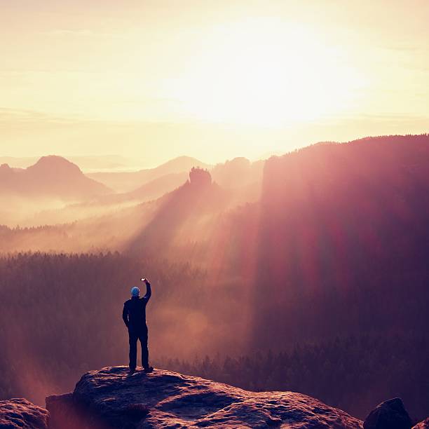 istock Hiker with smart phone on peak of mountain, spring sunrise. 508158842