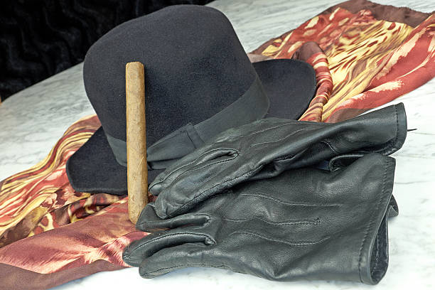 istock Black hat on a brown scarf with black leather gloves 508162094