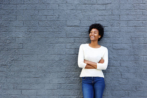 istock Happy african woman standing against a gray wall 508162332
