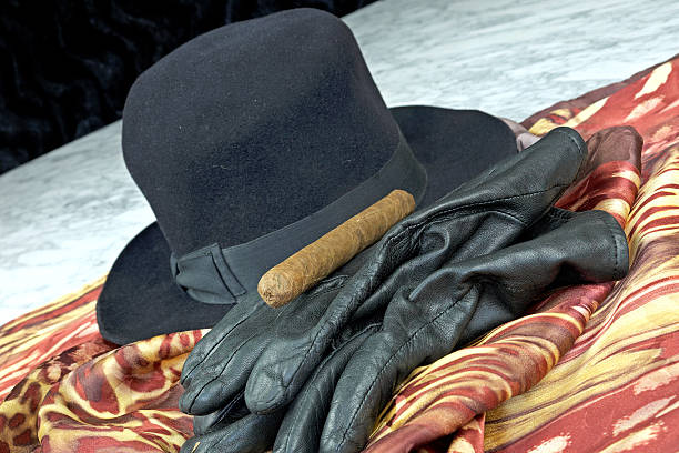 istock Black hat on a brown scarf with black leather gloves 508162464