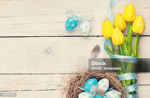 Easter Eggs In Nest And Yellow Tulips Stock Photo - Download Image Now - Easter, Above, Animal Nest