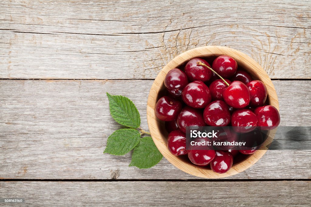 Ripe cherries on wooden table Ripe cherries on wooden table. View from above with copy space Above Stock Photo