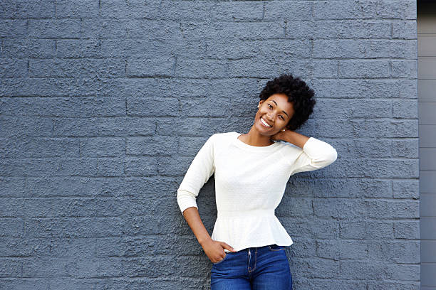 istock Smiling young african woman posing against gray wall 508164158