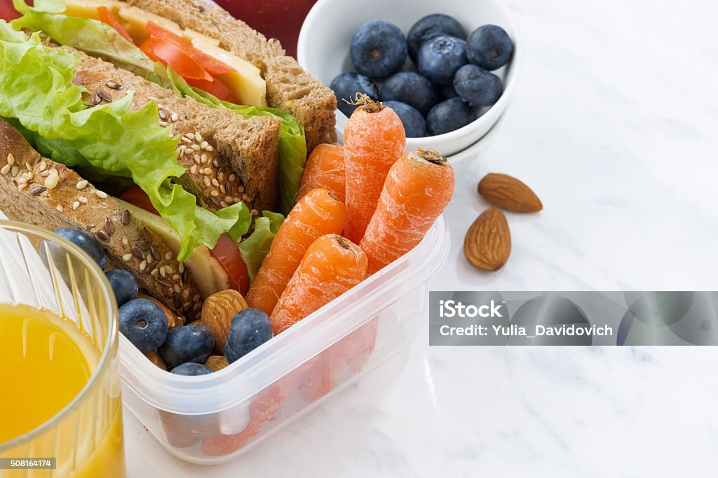 lunch box with sandwich of wholemeal bread on white background lunch box with sandwich of wholemeal bread on white background, closeup Packed Lunch Stock Photo