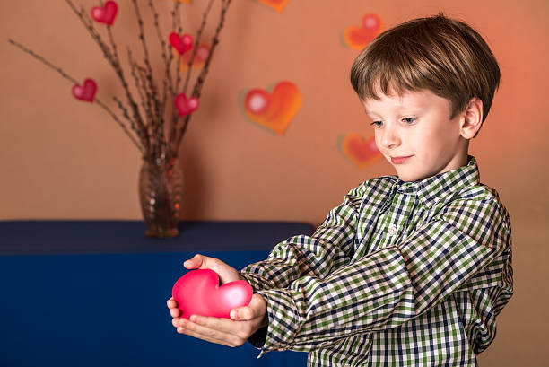 istock Boy gives a pink heart on Valentines Day. 508164282