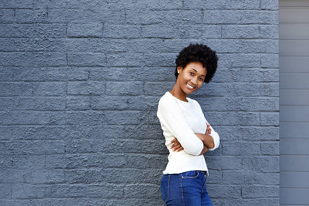 istock Confident young woman smiling with arms crossed 508164544