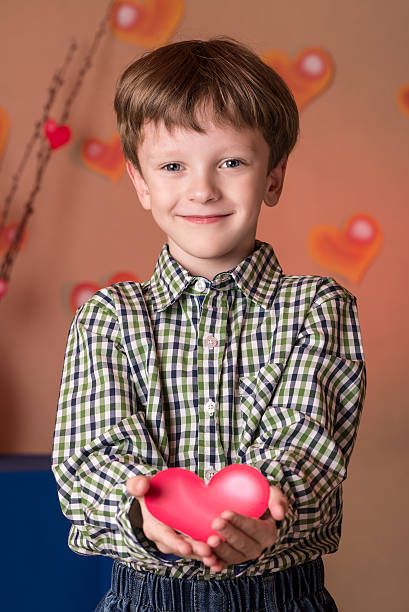 istock Boy gives a pink heart on Valentines Day. 508165022