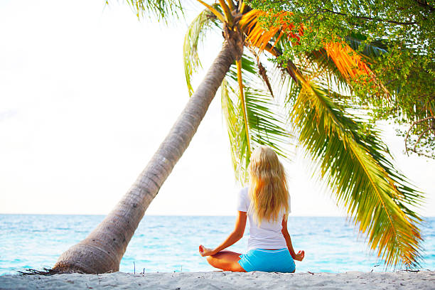 istock yoga woman under palm 508166443