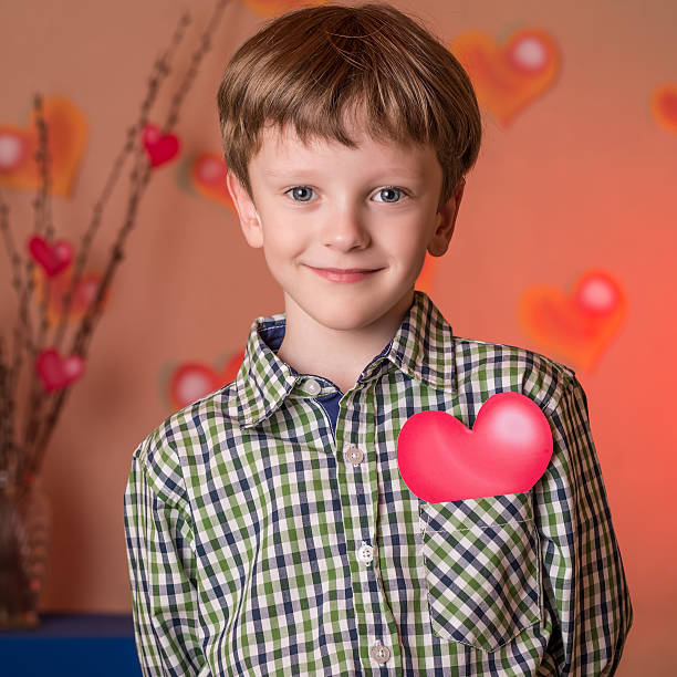 istock Boy gives a pink heart on Valentines Day. 508166742