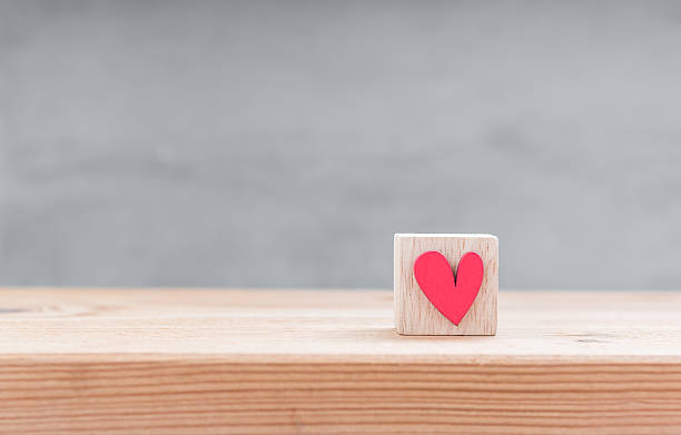 istock One red heart shape in wood cube on wood table 508166914