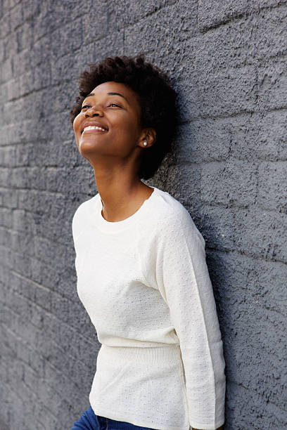 istock Relaxed young african woman leaning to a wall 508166936