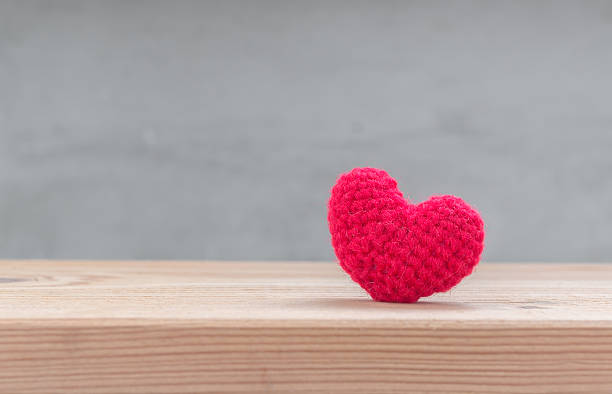 istock Red heart shape silk on wood table 508167026