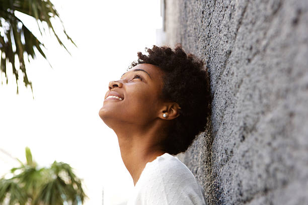 istock Young woman leaning to a wall outside and looking up 508167712