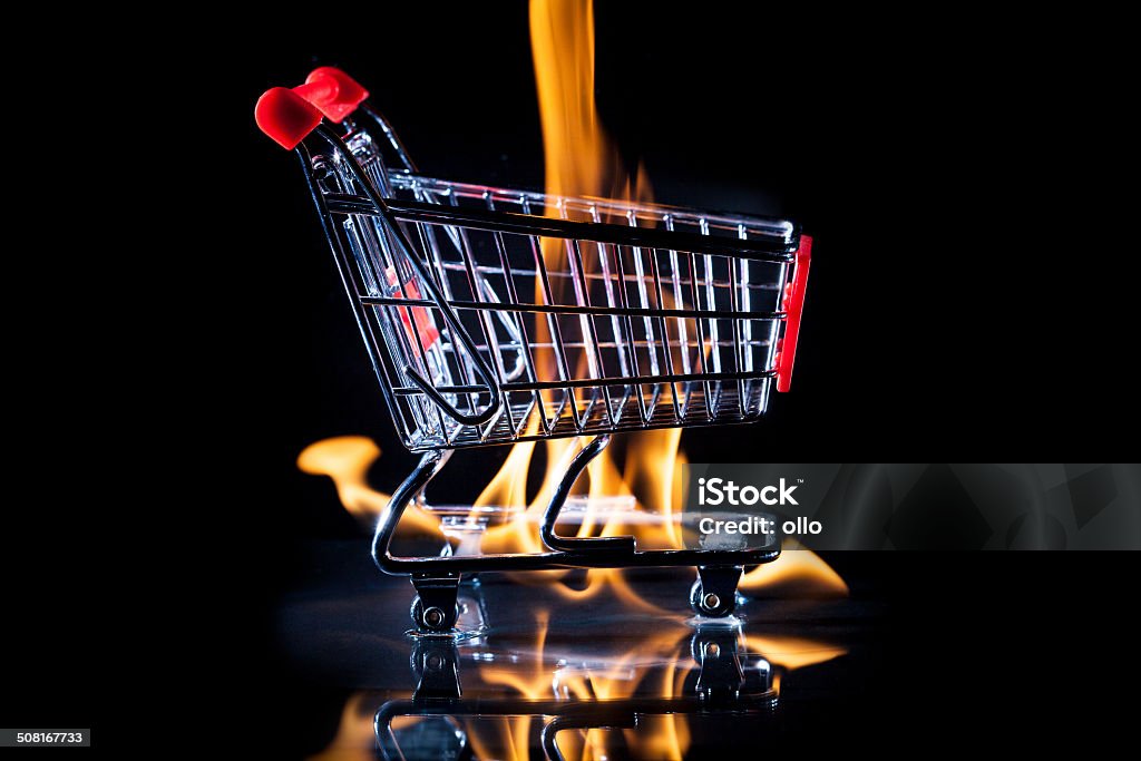 Burning shopping cart Burning shopping cart, black background Fire - Natural Phenomenon Stock Photo