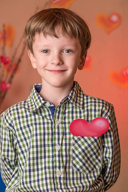 istock Boy gives a pink heart on Valentines Day. 508167806