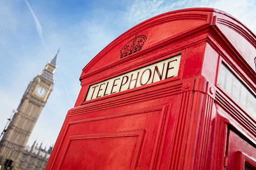 London telephone booth in front of  big ben and the houses of parliament in England