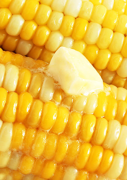 Melting butter on corn on the cob stock photo
