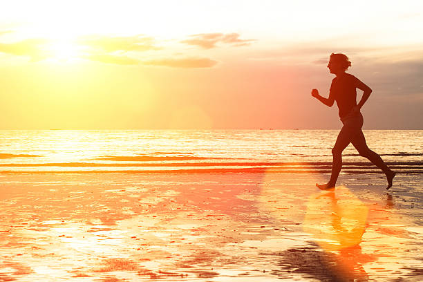 istock Young woman jogging on the beach at sunset. 508170321