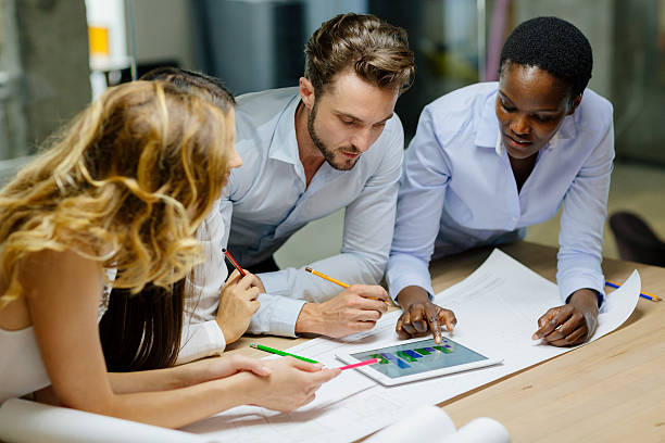 istock Multiethnic Team of architects reviewing architectural model in the office. 508171173