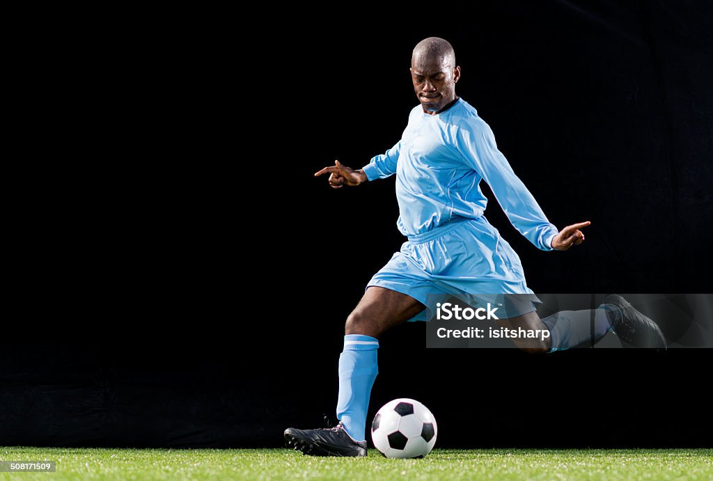 Soccer Player In Action Soccer player kicking the ball. Soccer Player Stock Photo