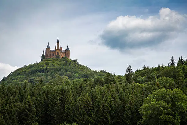 Hohenzollern Castle in Germany on a wooded mountain.