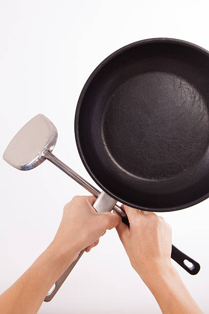 istock holding old saucepan and spatula with clipping path 508172767
