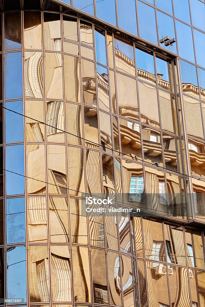 Glass facade reflection of stone facade on modern glass facade Abstract Stock Photo