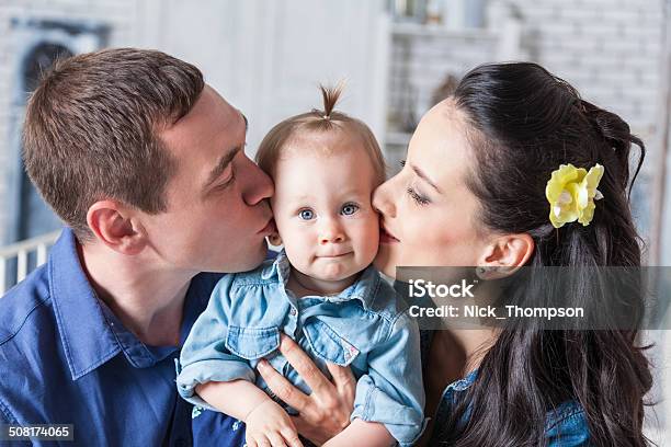 Mother And Father Kissing His Yearold Daughter Stock Photo - Download Image Now - Adult, Affectionate, Baby - Human Age